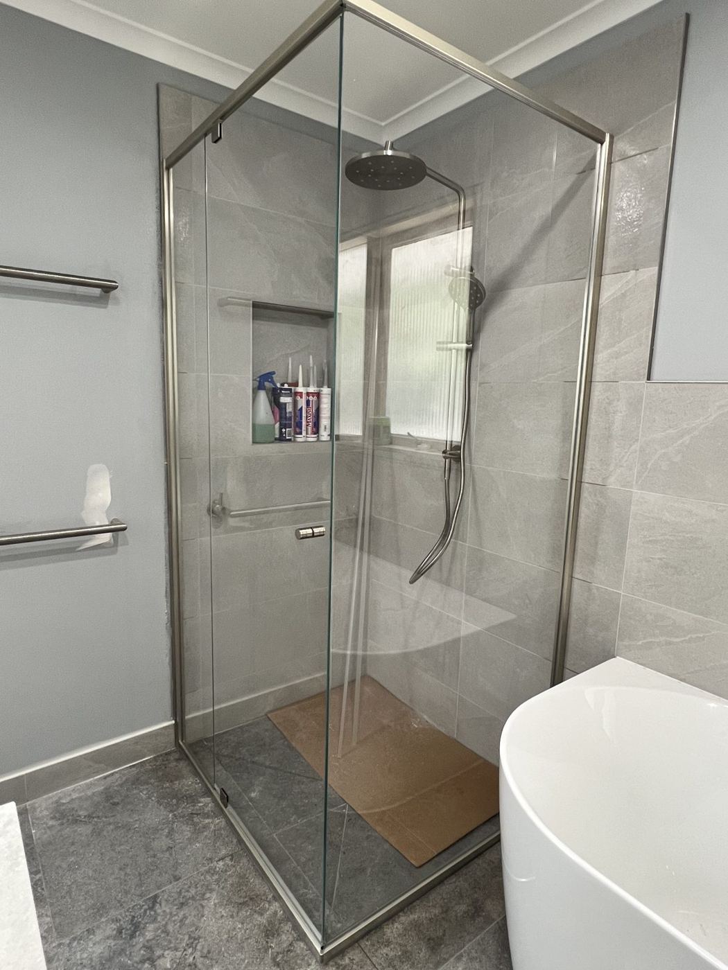 Brushed nickel semi-frameless shower