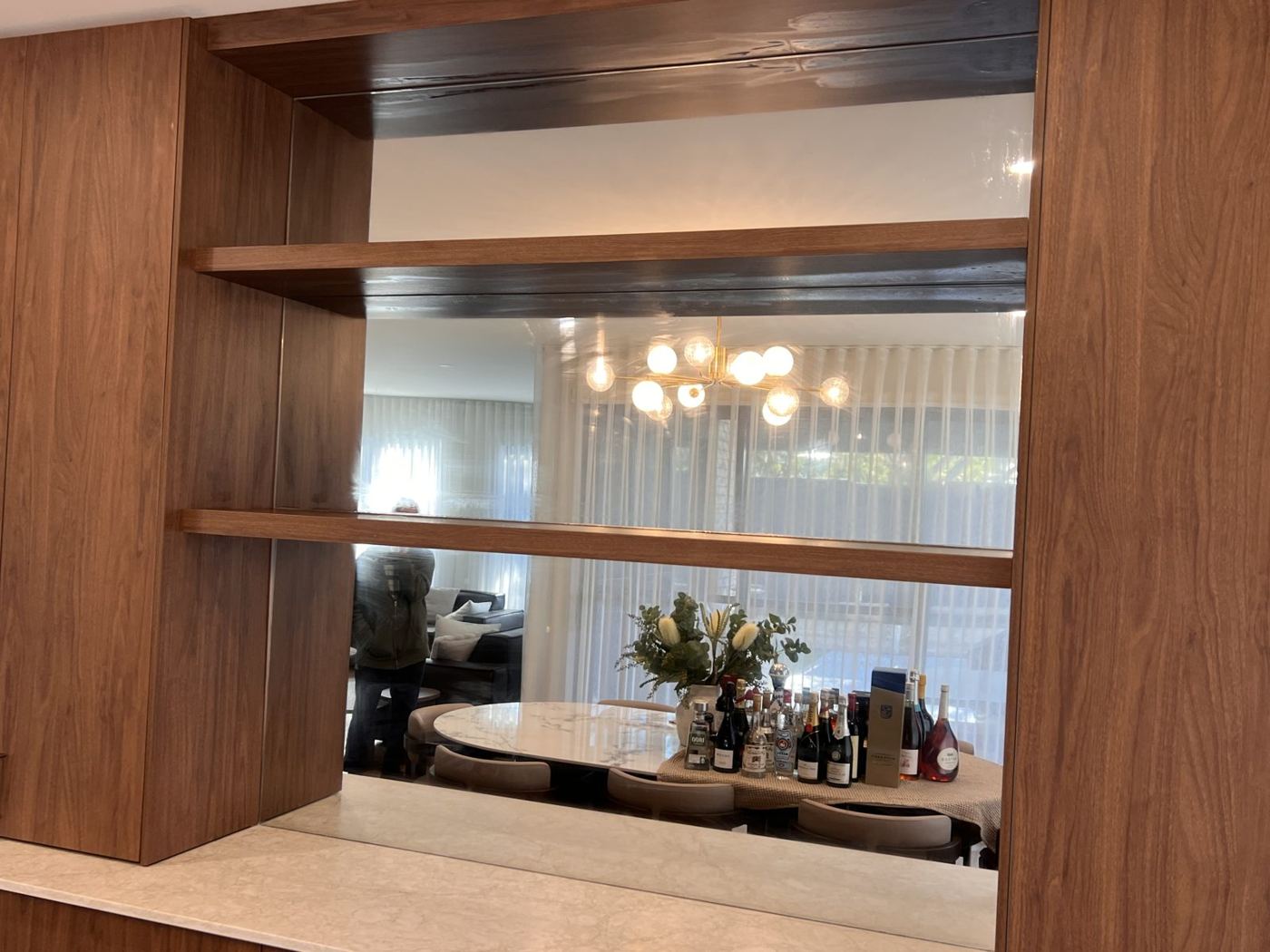 Feature mirror set into timber shelving