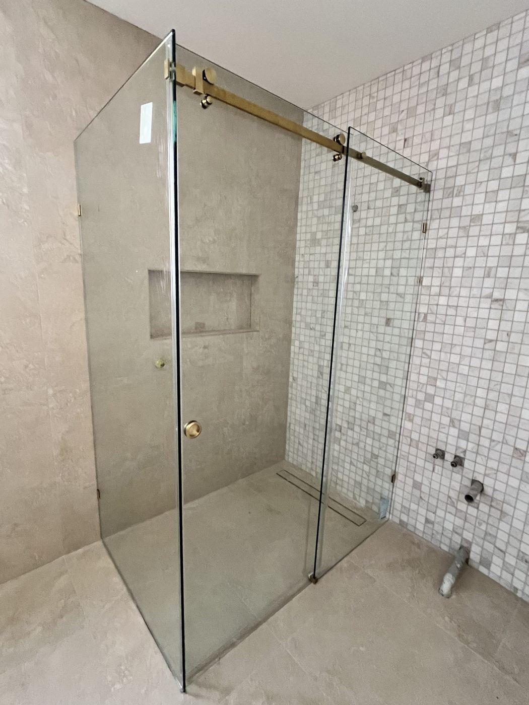 Frameless sliding shower door on a top rail