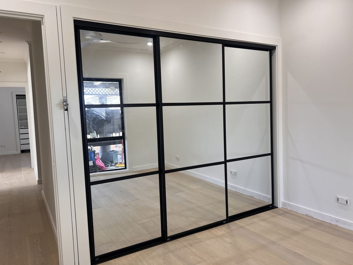 Black-framed glass sliding wardrobe doors