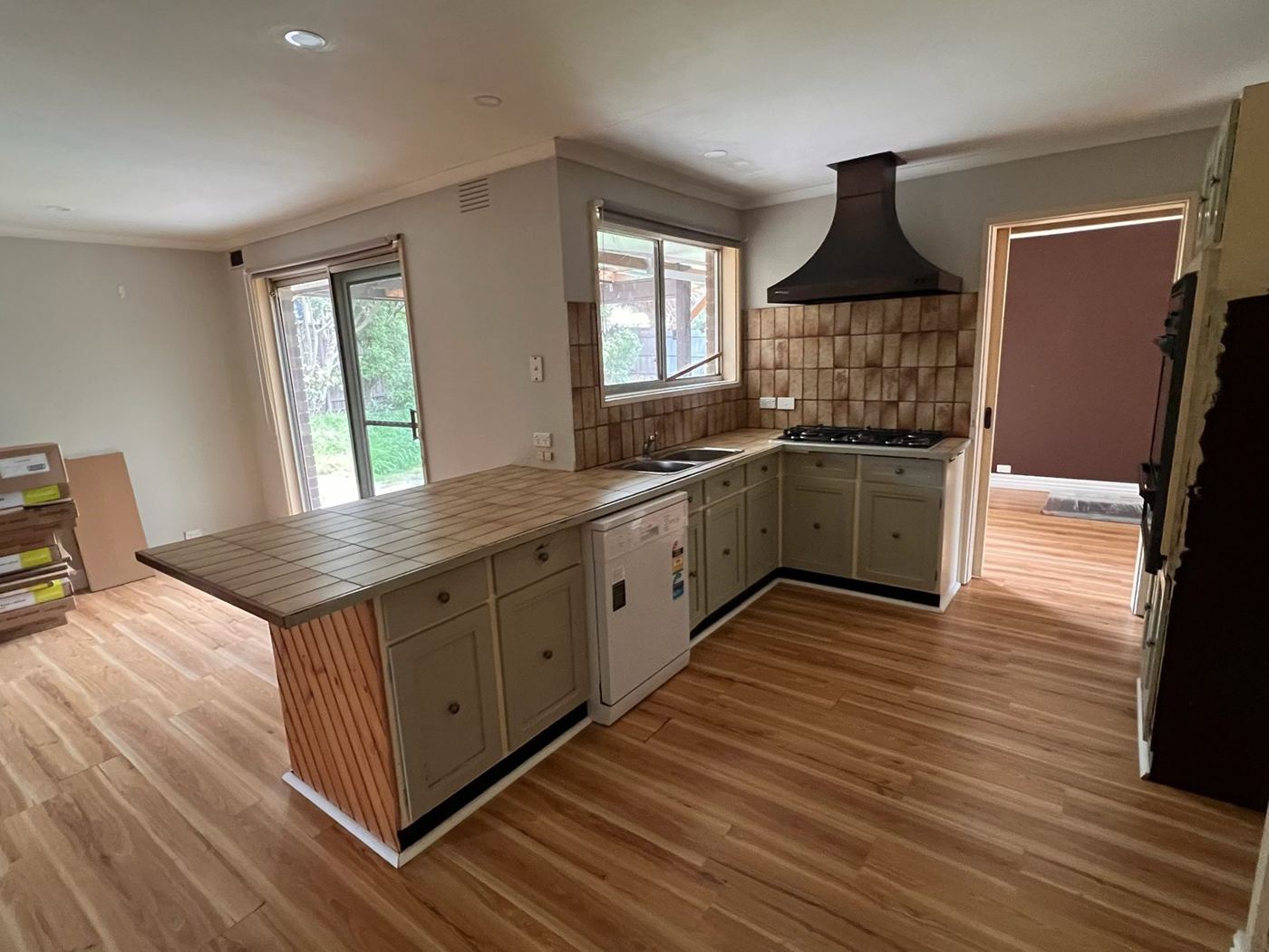 Kitchen before renovation, with tiled benchtop